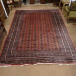 A large salmon ground Afghan Tekke design carpet, 370cm x 284cm