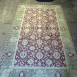A very large green and red ground Persian design carpet, 552cm x 337cm (viewing by appointment only)