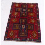 A red ground Beluchi rug, 135cm x 87cm