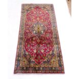 A red ground Kashan rug, 214cm x 100cm