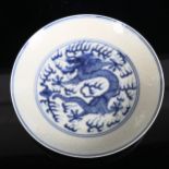 A Chinese blue and white porcelain 'Dragon' plate, depicting 5-claw dragon chasing flaming pearl,