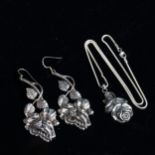 A pair of sterling silver floral design pendant earrings, and a similar necklace