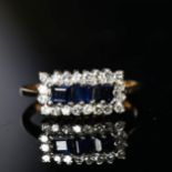 A 9ct gold ring set with a band of blue and white sapphires, size N