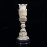 An early 20th century Indian ivory vase, Taj Mahal and animal decoration, on hardwood base, height