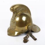 A late 19th/early 20th century Merryweather pattern brass fireman's helmet, with original leather