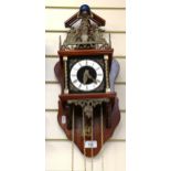 An ornate brass-mounted wall clock, with weights