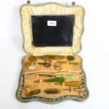 An Art Deco manicure set in case with mirror, 27.5cm across