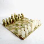 An onyx chess set and board, King height 10cm, board 36cm