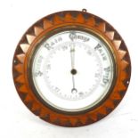 An oak starburst cased wall barometer, diameter 25cm