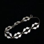 A sterling silver and white enamel leaf design bracelet