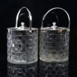 A pair of cut-glass biscuit barrels with plated mounts