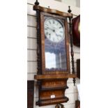 A wall clock in ornate marquetry decorated case, with turned spindles, height 85cm