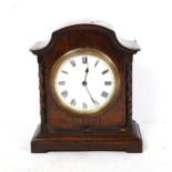 A small early 20th century oak-cased mantel clock, with barley twist supports, case height 19cm,