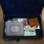 A blue leather suitcase containing various Vintage cigarette cards