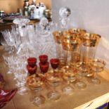 3 decanters and stoppers, gilded beakers and matching liqueurs, Champagne flutes etc