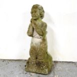 A weathered concrete praying child garden ornament, height 67cm