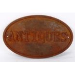 A weathered cast-iron Antiques shop advertising sign, 21cm x 34cm