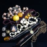 An ivory bead necklace, a Baltic amber pendant on silver chain etc