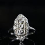 An 18ct white gold marquise ring, set with 3 central diamonds in platinum settings, size F