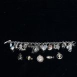 A silver charm bracelet and various loose charms