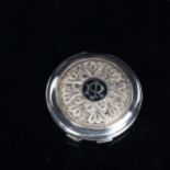 A Middle Eastern unmarked white metal niello compact, filigree decoration, with duck in flight,