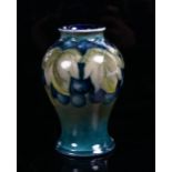 A small Moorcroft Blueberry pattern baluster vase, height 10cm (chip on base)