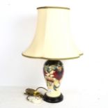 A Moorcroft cream ground table lamp, with tube-lined floral decoration, and shade, height overall