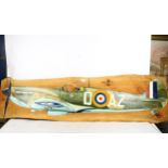 A painted wooden sign depicting an early aeroplane, length 150cm