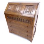 A linenfold carved and panelled oak 4-drawer bureau, W77cm, H92cm, D43cm