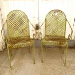 A pair of wrought-iron garden chairs