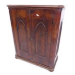 A 19th century mahogany side cabinet of small size, with lancet-panelled sides and doors, on bun