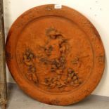 A terracotta circular wall plaque, depicting a Goddess and cherubs, diameter 60cm