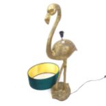 A decorative floor standing gilt composite floor lamp in the form of a flamingo, with green shade,