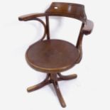 An early 20th century Thonet rise and fall swivel desk chair, with paper label to the underside