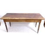 An Antique elm and pine plank-top kitchen table, with end frieze drawer and opposing slide, raised