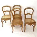 A set of 4 oak balloon-back dining chairs with cane panelled seats