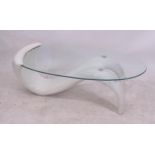 A contemporary style coffee table of free-form design, with oval glass top, L125cm, H44cm, D59cm