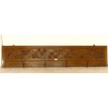 A carved oak Art Nouveau style hanging coat rack with 4 hooks, inscribed In Te Domine Confido