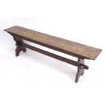 A stained oak bench on shaped ends, L153cm, H46cm, D26cm