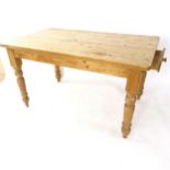 An Antique stained pine kitchen table, on turned legs, with single end frieze drawer, W140cm, H76cm,