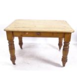 A Victorian pine round-cornered kitchen table, with single frieze drawer, on turned legs, W120cm,