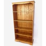 A polished pine open bookcase with 4 adjustable shelves, W95cm, H190cm, D32cm