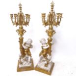 A pair of decorative gilded 5-branch table candelabras, supported by cherubs, height 107cm