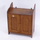 A small Arts and Crafts oak hanging 2-door cupboard, W37cm, H46cm, D22cm