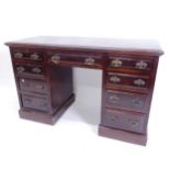 An Edwardian mahogany kneehole pedestal writing desk, with fitted drawers, W130cm, H80cm, D56cm,