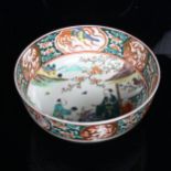 A Chinese porcelain bowl on foot with figure decoration, 18cm across