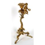 A 19th century gilt-brass putti and acorn candlestick, with ram's head and hoof feet, height 30cm