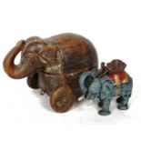 A cast-iron elephant novelty money box, and a carved wood elephant box on wheels, height 18cm