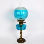A Vintage brass and blue glass oil lamp, with funnel and shade, height 57cm