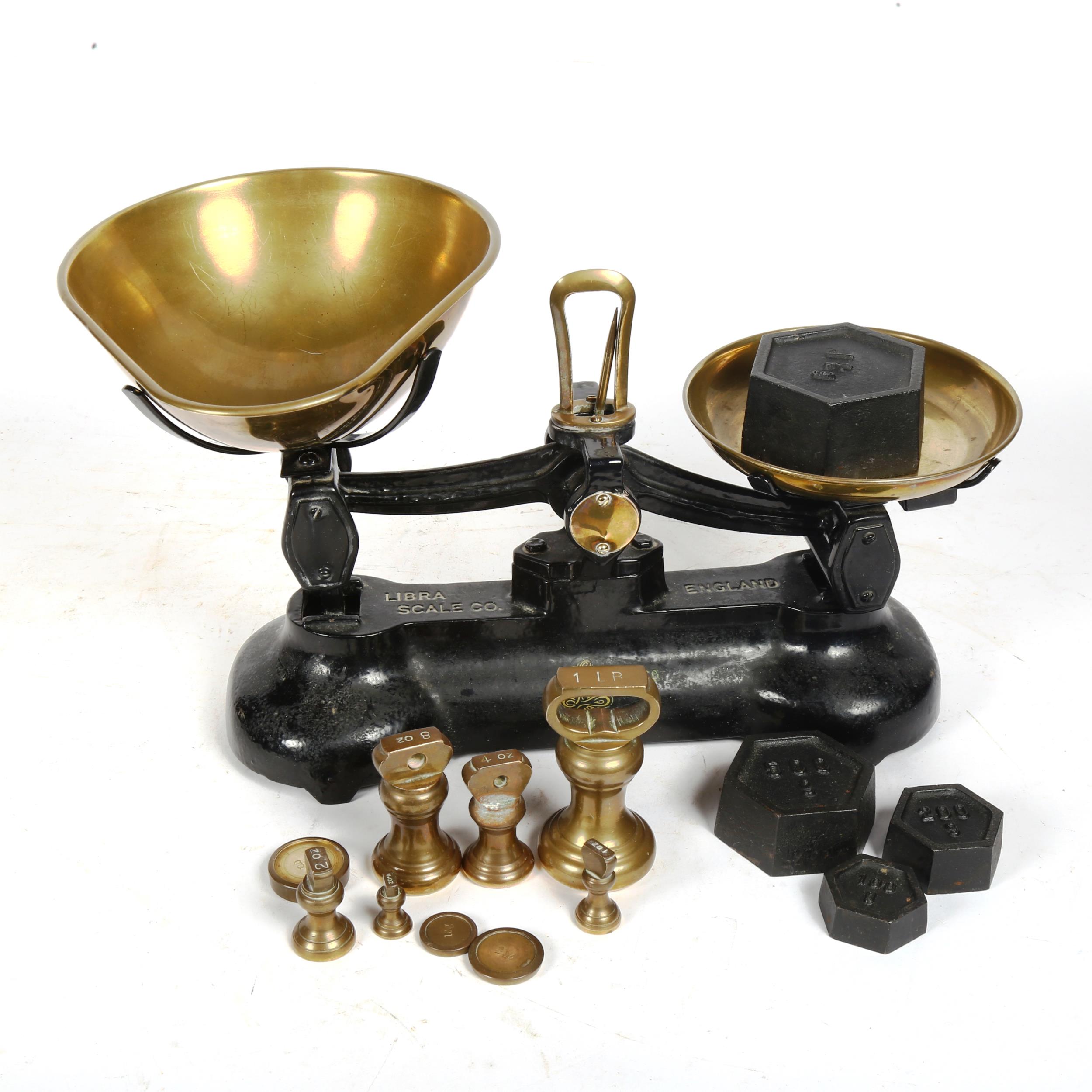 Libra cast-iron balance scale with brass pans and weights